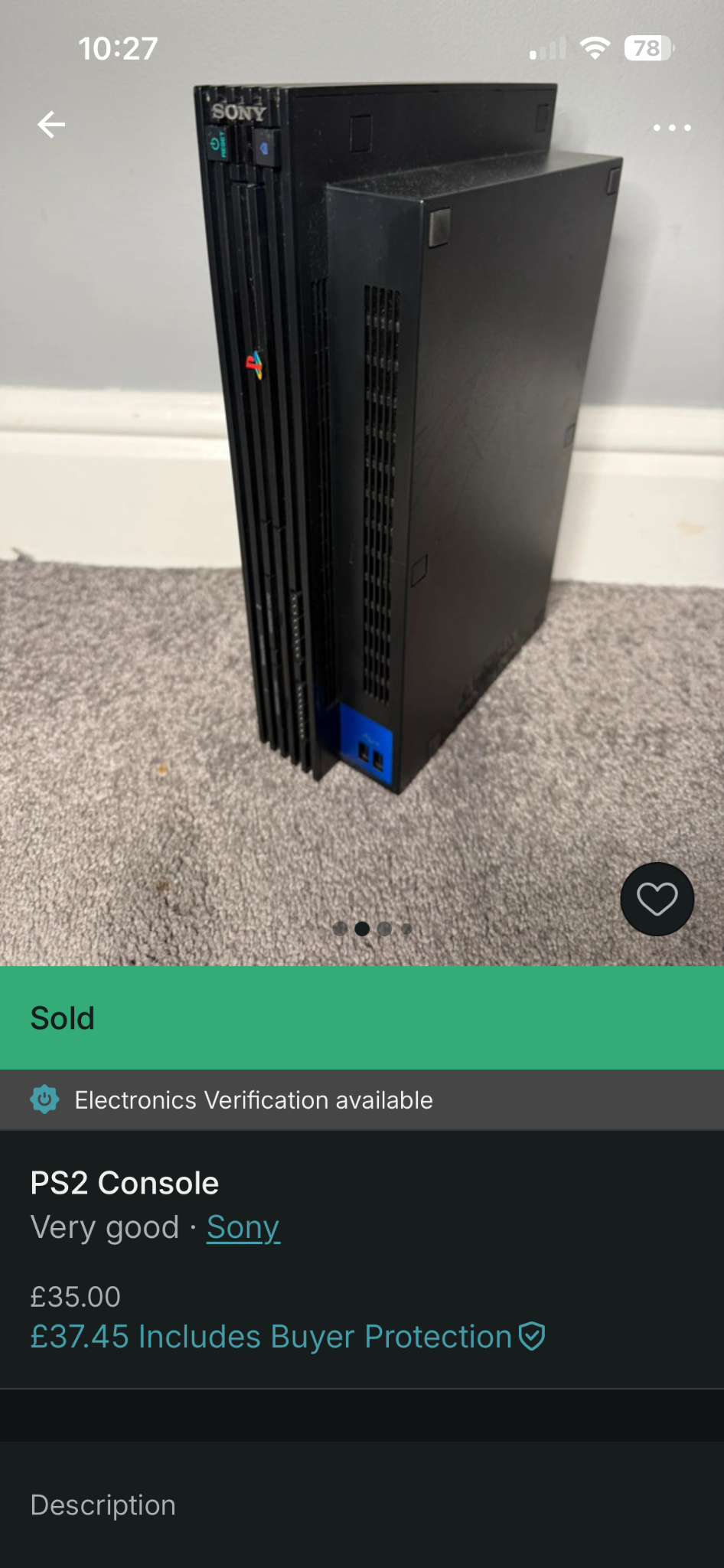 Marketplace listing photo of a PlayStation 2 console standing upright on carpet.