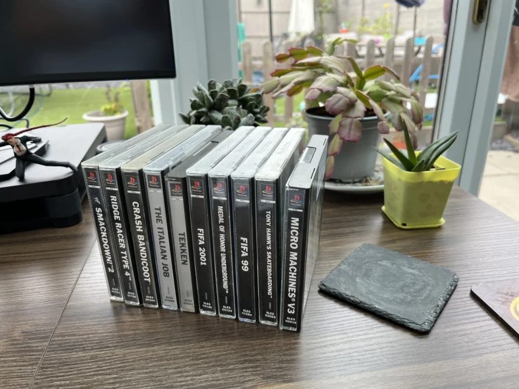A close-up view showing the spines of a collection of PlayStation 1 game cases.