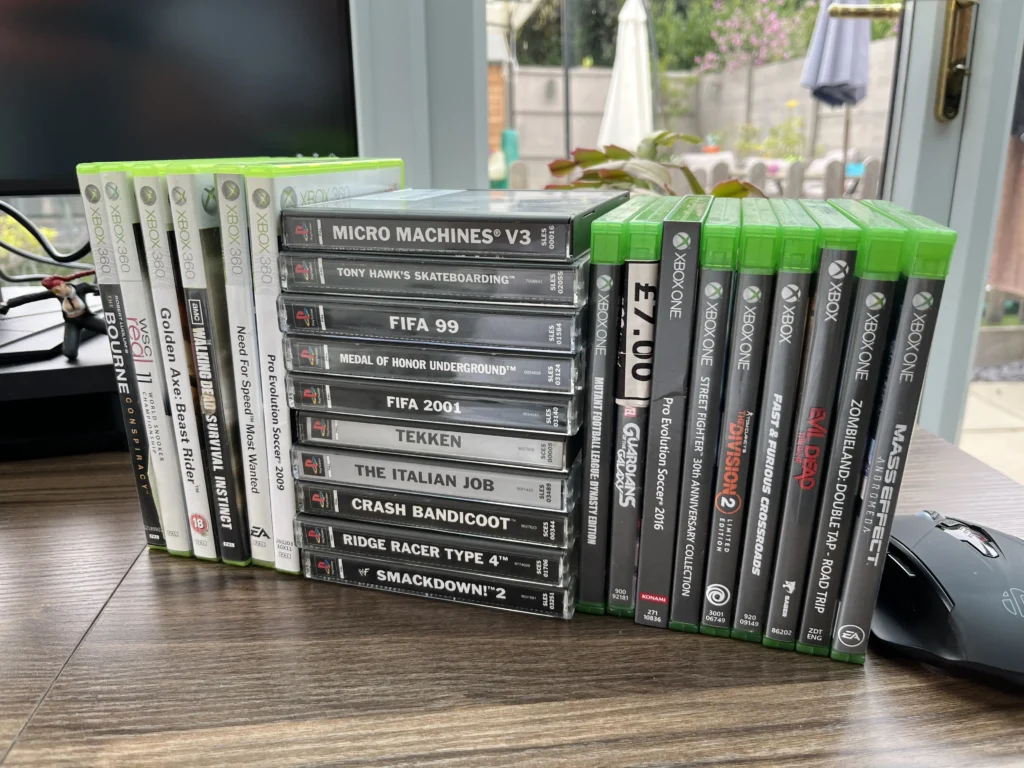 A large stack combining various console games from Xbox One, Xbox 360, and original PlayStation titles.